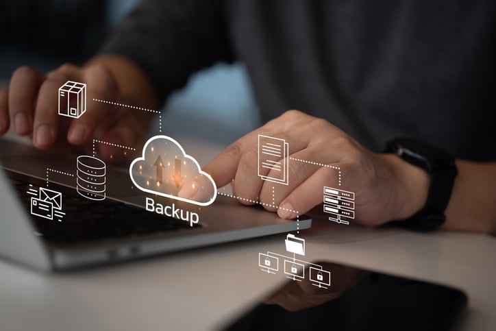 Businessman Interacting with a Backup Interface virtual cloud network data security system internet online with futuristic holographic digital technology.